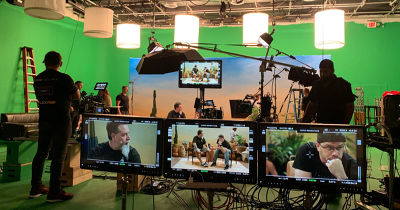 Thunder4 Productions team on set with green screen and lighting equipment
