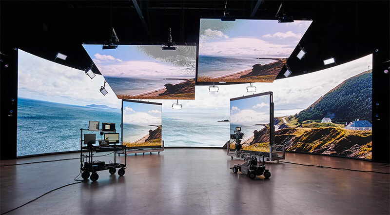 A cliffside ocean view is displayed on a virtual production stage