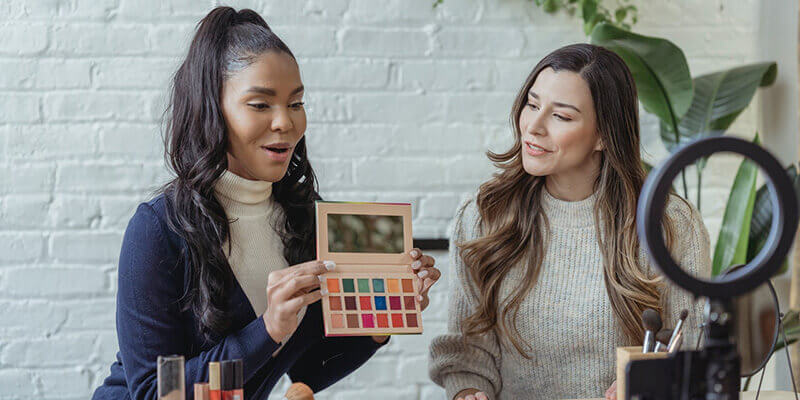 Beauty-Influencer testen eine Farbpalette vor der Kamera