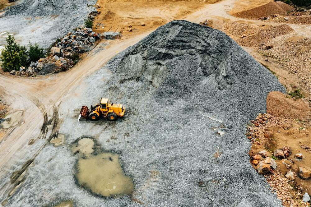 Aerial view of Truck excavator in open sand quarry rubble in Finland. Placeholder image