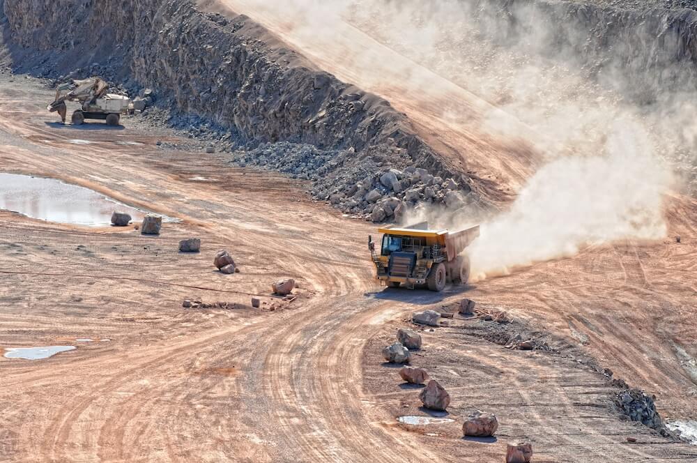 dumper truck driving in an active quarry mine of porphyry rocks. digging. Placeholder image