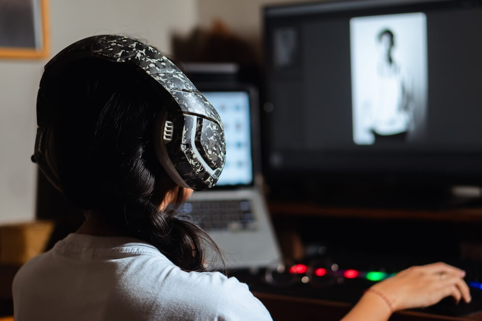 Woman with headphones working on photo editing Wasabi cloud storage